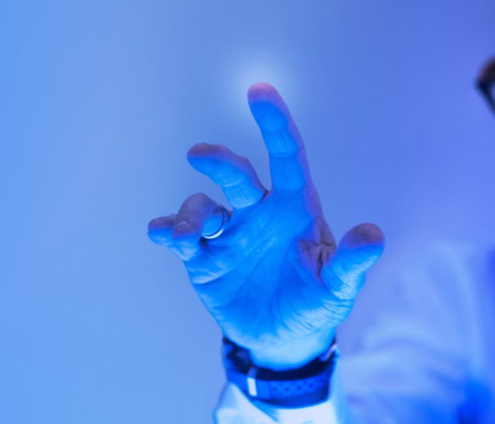 Man touching the futuristic blue screen